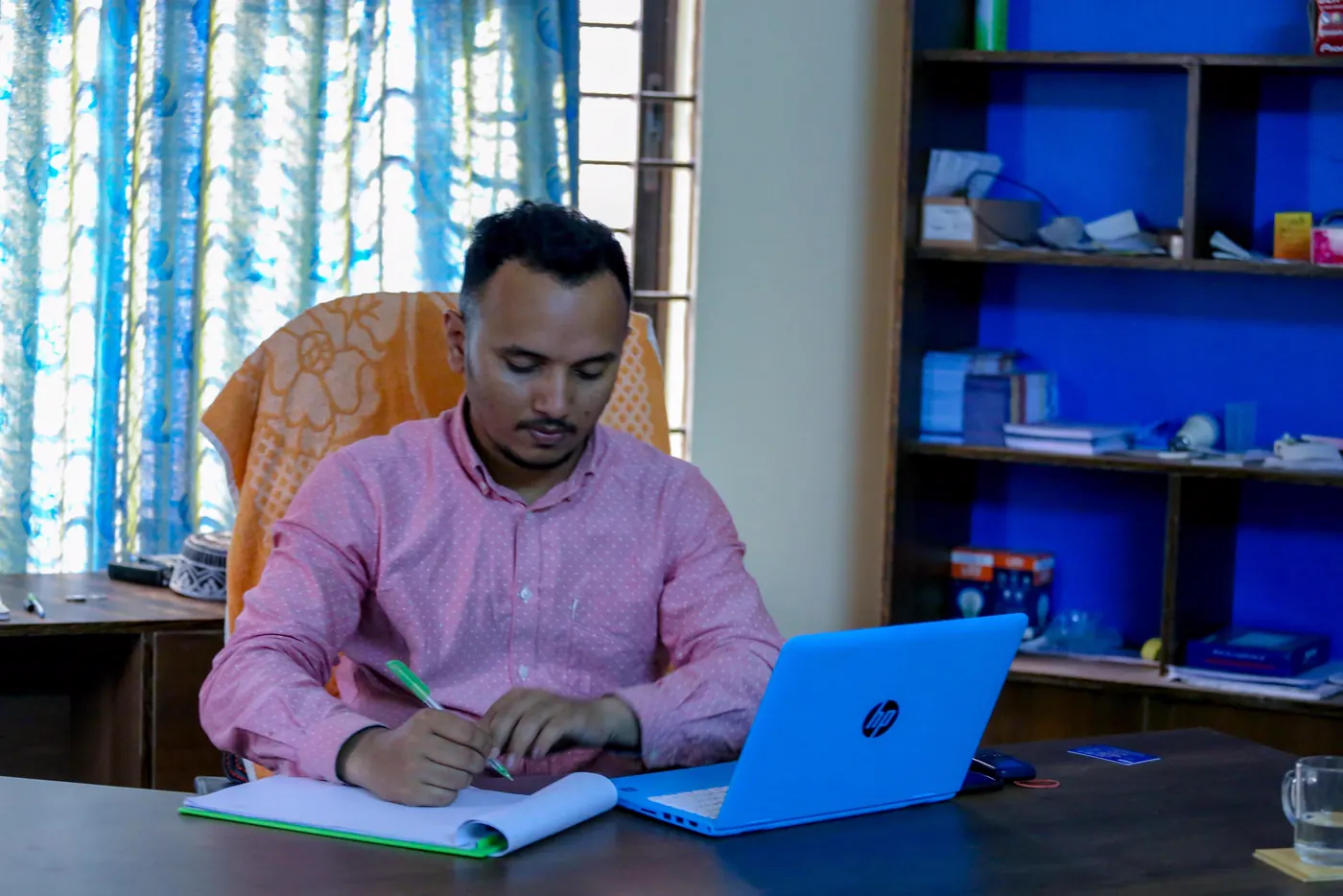 A FILP organiser working at a desk at the training centre